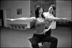 Woman Undertaking Pilates Stretching Exercise On The Trapeze Table