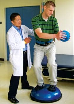 Performing trunk rotation holding a weighted ball