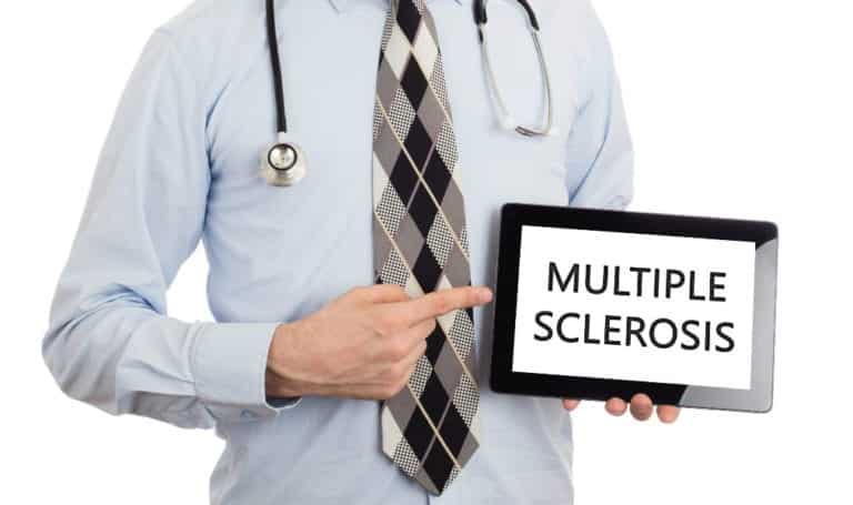 doctor pointing to tablet displaying the words multiple sclerosis