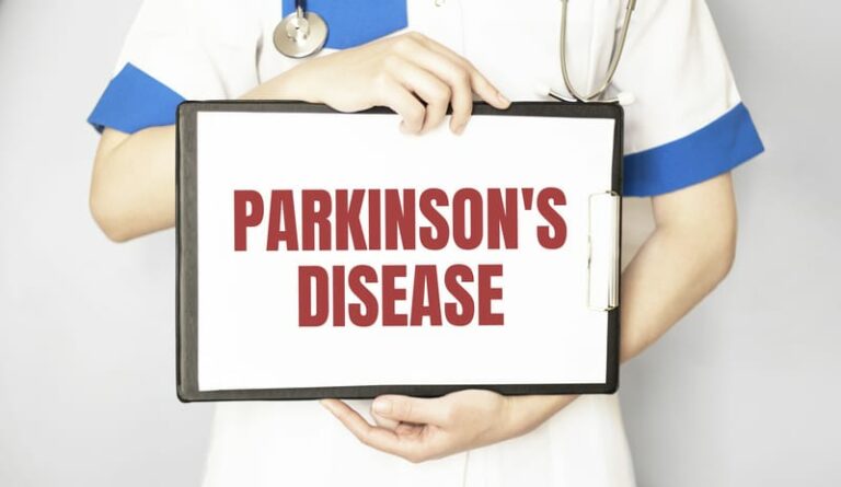closeup of Parkinson's Disease words displayed on tablet being held by doctor
